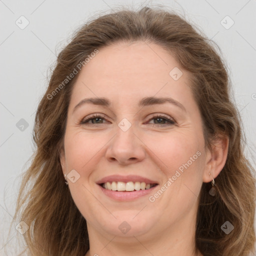 Joyful white adult female with long  brown hair and brown eyes