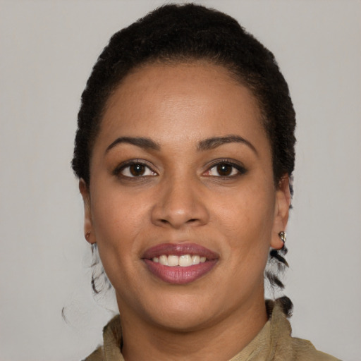 Joyful black young-adult female with short  brown hair and brown eyes