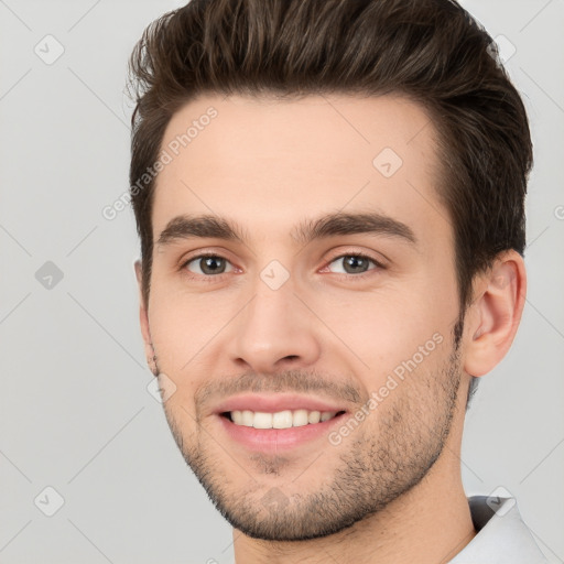 Joyful white young-adult male with short  brown hair and brown eyes