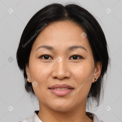 Joyful asian adult female with medium  brown hair and brown eyes