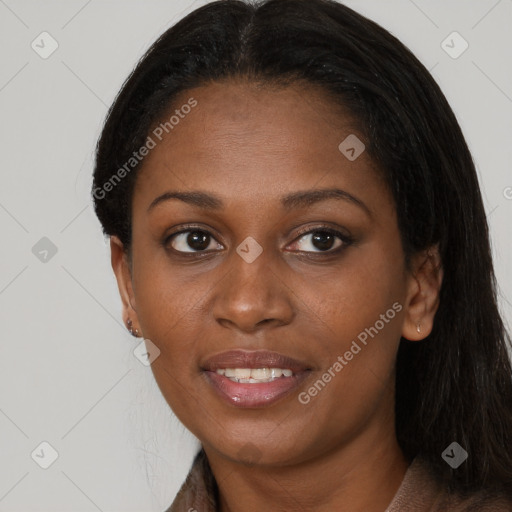 Joyful black young-adult female with long  brown hair and brown eyes