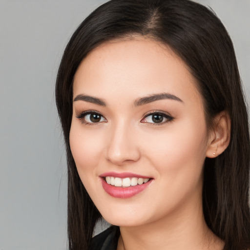 Joyful white young-adult female with long  black hair and brown eyes