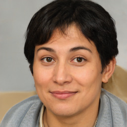 Joyful white adult female with medium  brown hair and brown eyes