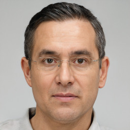Joyful white adult male with short  black hair and brown eyes
