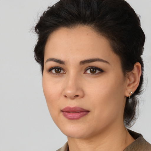 Joyful latino young-adult female with medium  brown hair and brown eyes