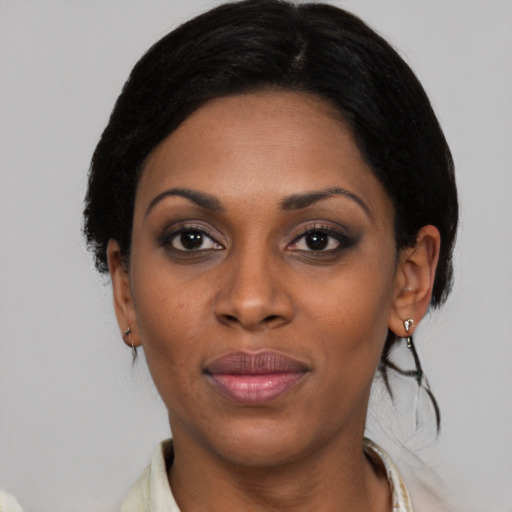 Joyful black young-adult female with medium  black hair and brown eyes