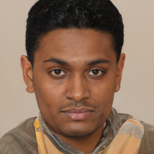 Joyful black young-adult male with short  brown hair and brown eyes