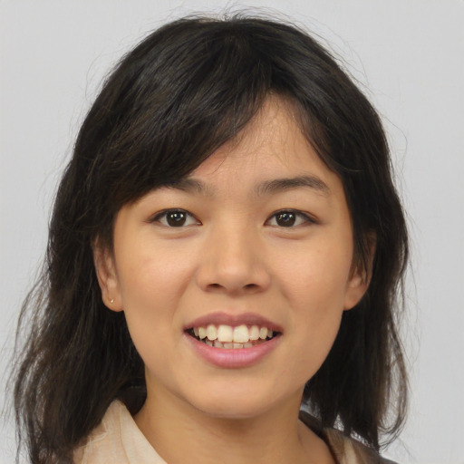 Joyful asian young-adult female with medium  brown hair and brown eyes