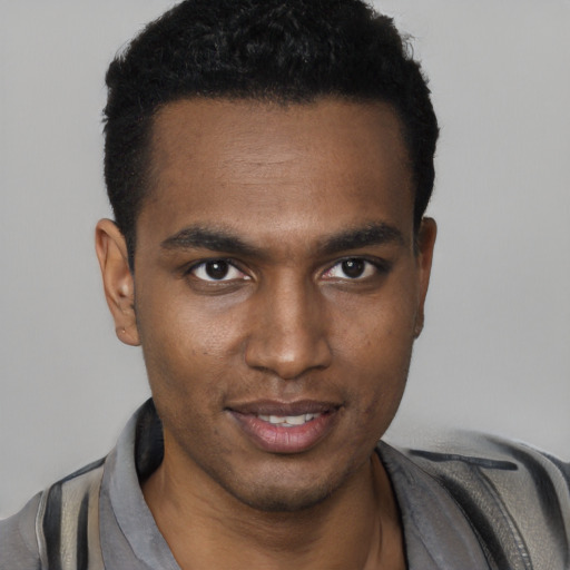 Joyful black young-adult male with short  black hair and brown eyes