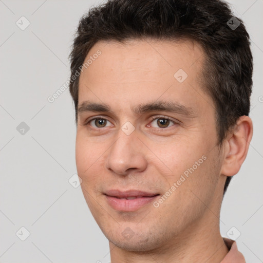 Joyful white young-adult male with short  brown hair and brown eyes