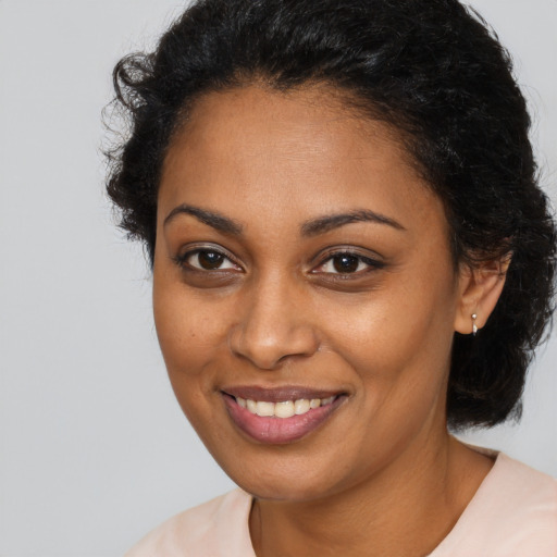 Joyful black young-adult female with short  brown hair and brown eyes
