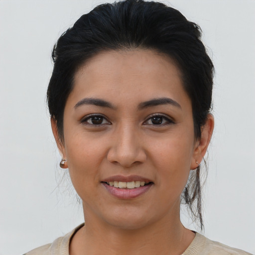 Joyful latino young-adult female with medium  brown hair and brown eyes