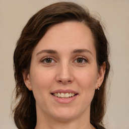 Joyful white young-adult female with medium  brown hair and green eyes