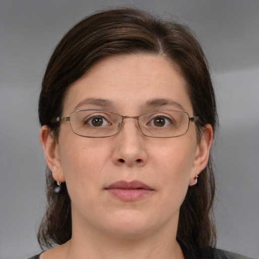 Joyful white adult female with medium  brown hair and brown eyes