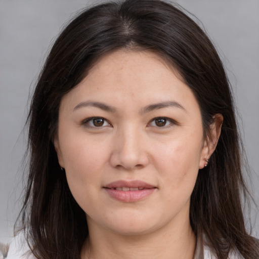 Joyful white young-adult female with long  brown hair and brown eyes