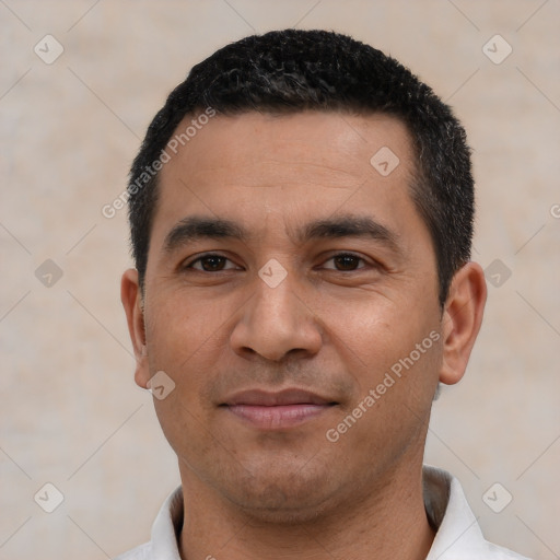 Joyful latino young-adult male with short  black hair and brown eyes