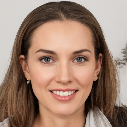 Joyful white young-adult female with long  brown hair and grey eyes