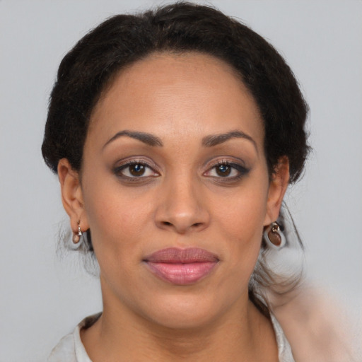 Joyful latino young-adult female with medium  brown hair and brown eyes