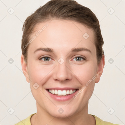 Joyful white young-adult female with short  brown hair and grey eyes