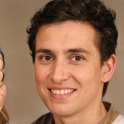 Joyful white adult male with short  brown hair and brown eyes