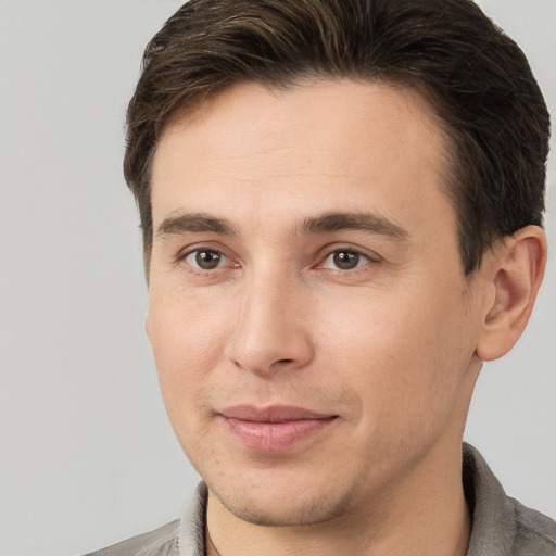 Joyful white young-adult male with short  brown hair and brown eyes