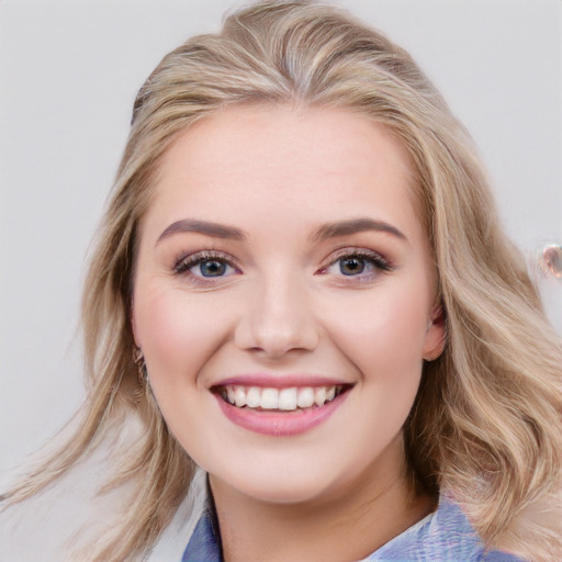 Joyful white young-adult female with medium  brown hair and blue eyes