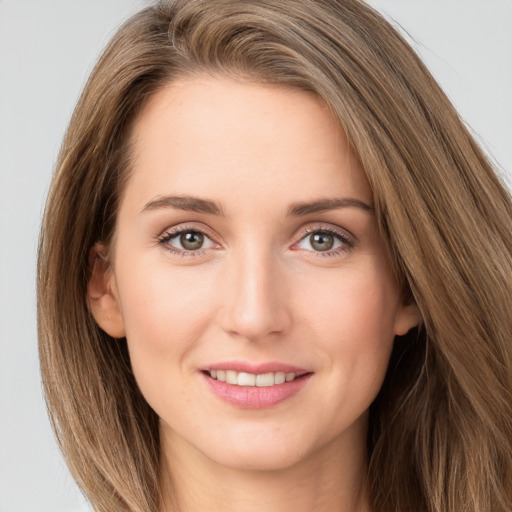 Joyful white young-adult female with long  brown hair and green eyes