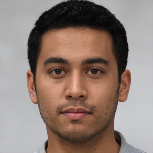Neutral latino young-adult male with short  black hair and brown eyes