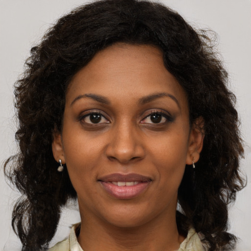 Joyful black young-adult female with medium  brown hair and brown eyes