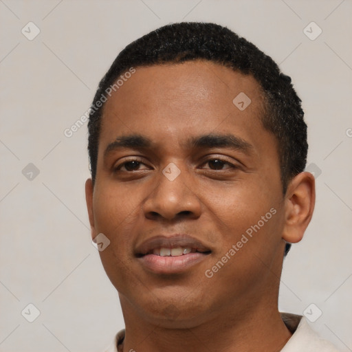 Joyful black young-adult male with short  black hair and brown eyes