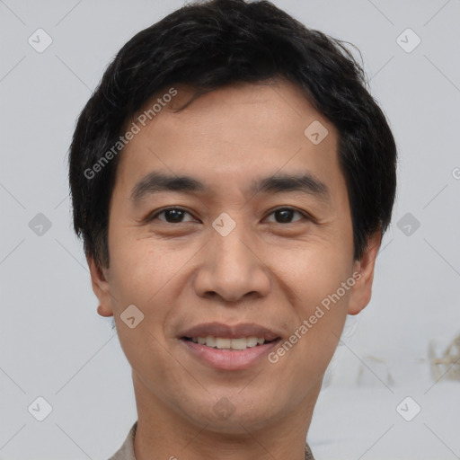 Joyful asian young-adult male with short  black hair and brown eyes