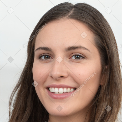 Joyful white young-adult female with long  brown hair and grey eyes