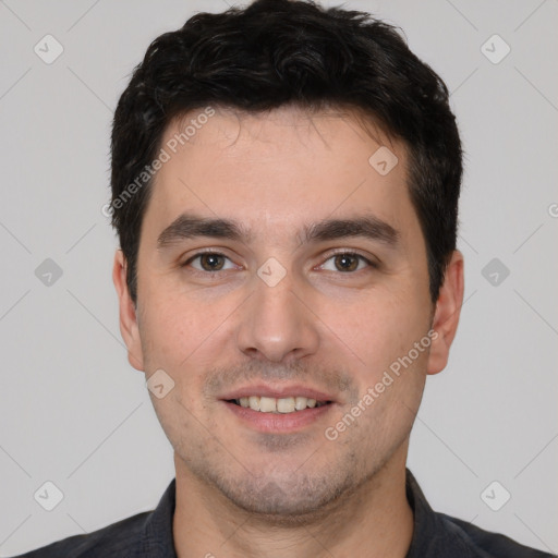 Joyful white young-adult male with short  black hair and brown eyes