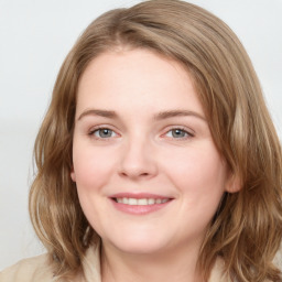 Joyful white young-adult female with medium  brown hair and blue eyes