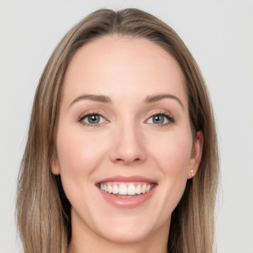 Joyful white young-adult female with long  brown hair and grey eyes