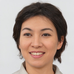 Joyful asian young-adult female with medium  brown hair and brown eyes