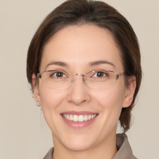 Joyful white adult female with medium  brown hair and brown eyes