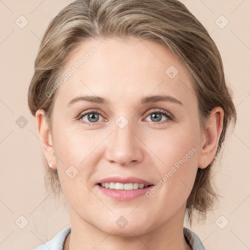 Joyful white young-adult female with medium  brown hair and blue eyes