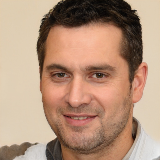 Joyful white adult male with short  brown hair and brown eyes