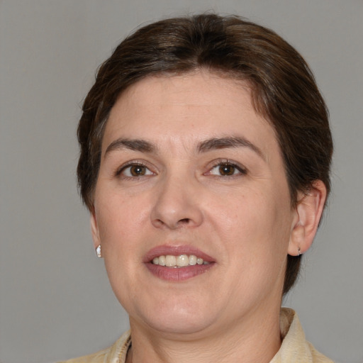 Joyful white adult female with medium  brown hair and brown eyes