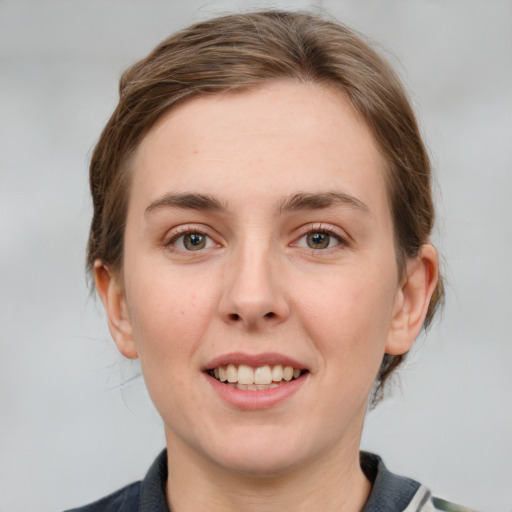 Joyful white young-adult female with medium  brown hair and grey eyes