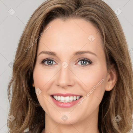 Joyful white young-adult female with long  brown hair and green eyes