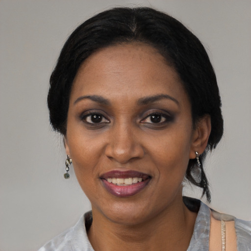 Joyful black adult female with short  black hair and brown eyes