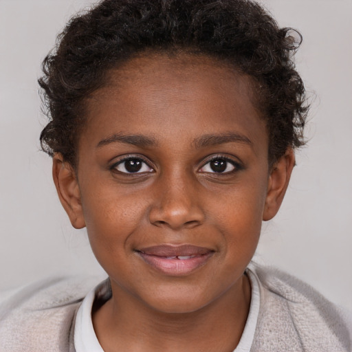 Joyful black child female with short  brown hair and brown eyes