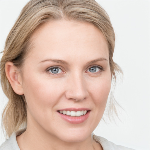 Joyful white young-adult female with medium  brown hair and blue eyes