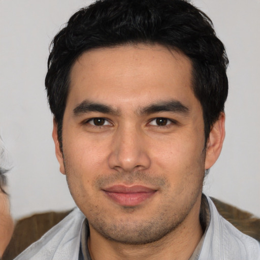 Joyful asian young-adult male with short  black hair and brown eyes
