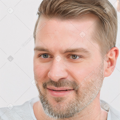 Joyful white adult male with short  brown hair and grey eyes