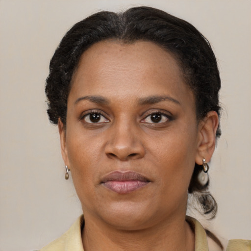Joyful black young-adult female with medium  brown hair and brown eyes