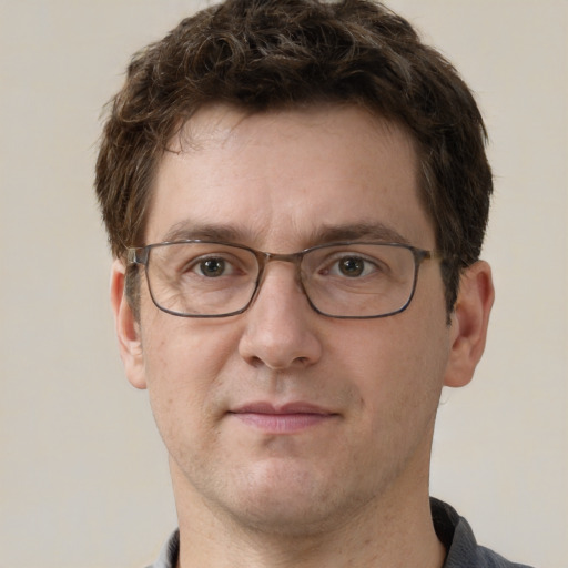 Joyful white adult male with short  brown hair and grey eyes