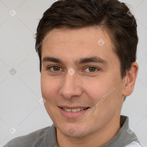 Joyful white young-adult male with short  brown hair and brown eyes